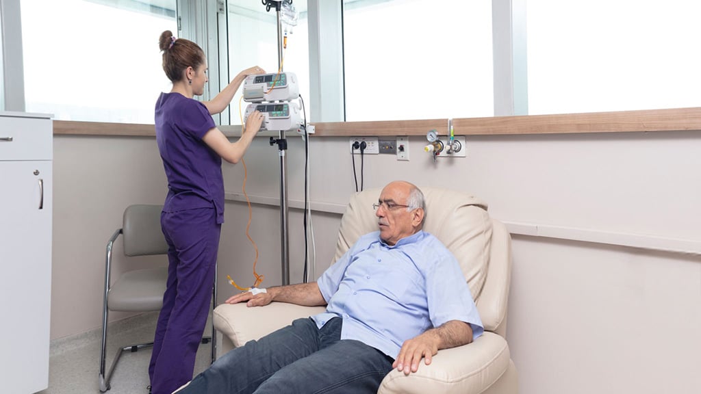 Patient receiving intravenous radioligand therapy during clinical trials.