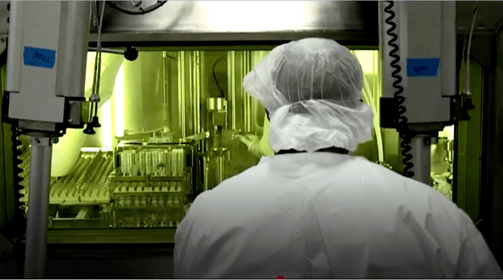 Lab worker inspecting vials.